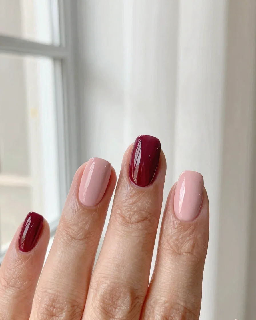 Macro editorial photograph of a cream-toned manicure with a powde